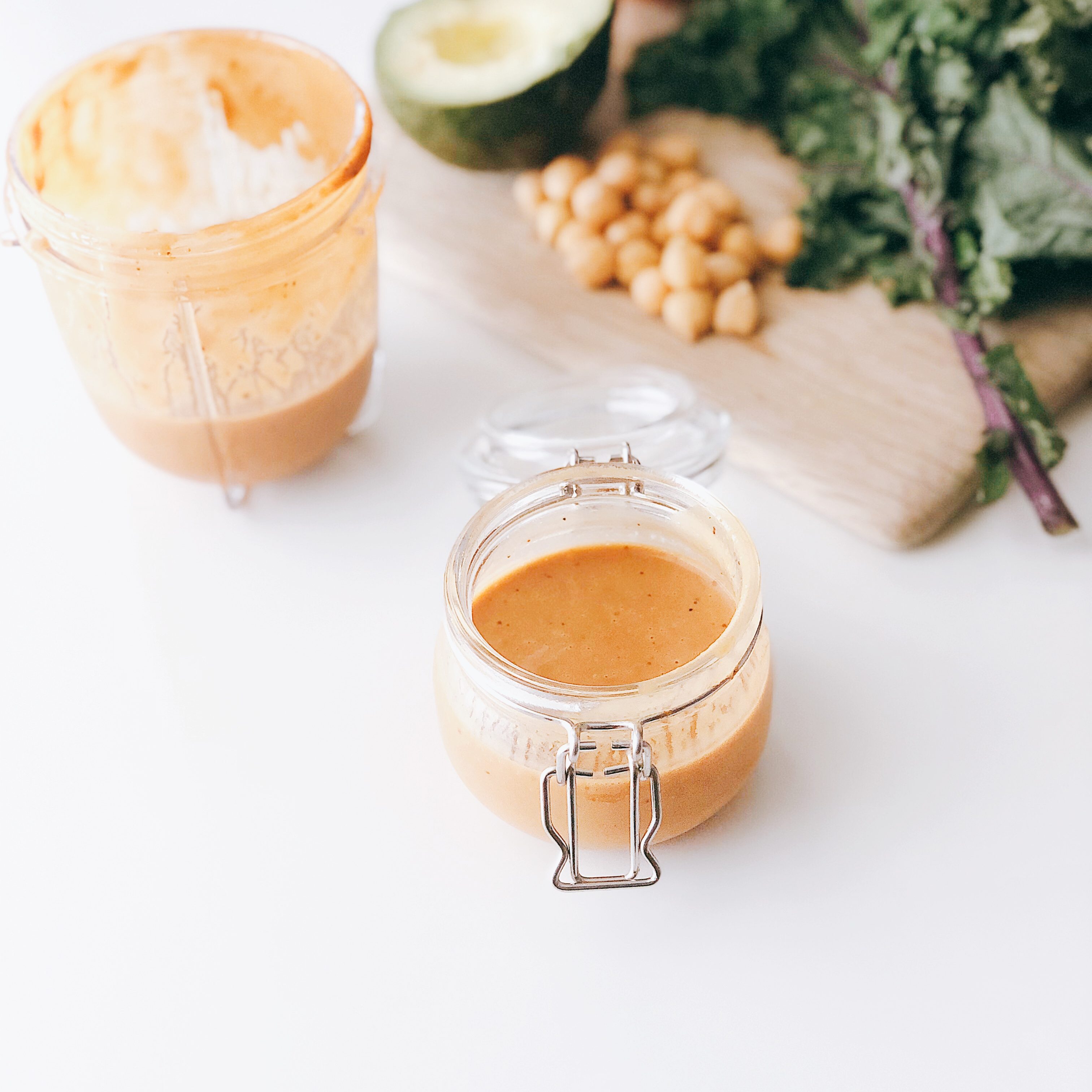 5-minute ginger miso dressing with vegetables on a cutting board in the background